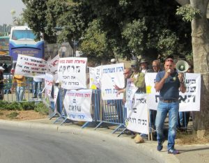 Protest signs near Knesset entrance