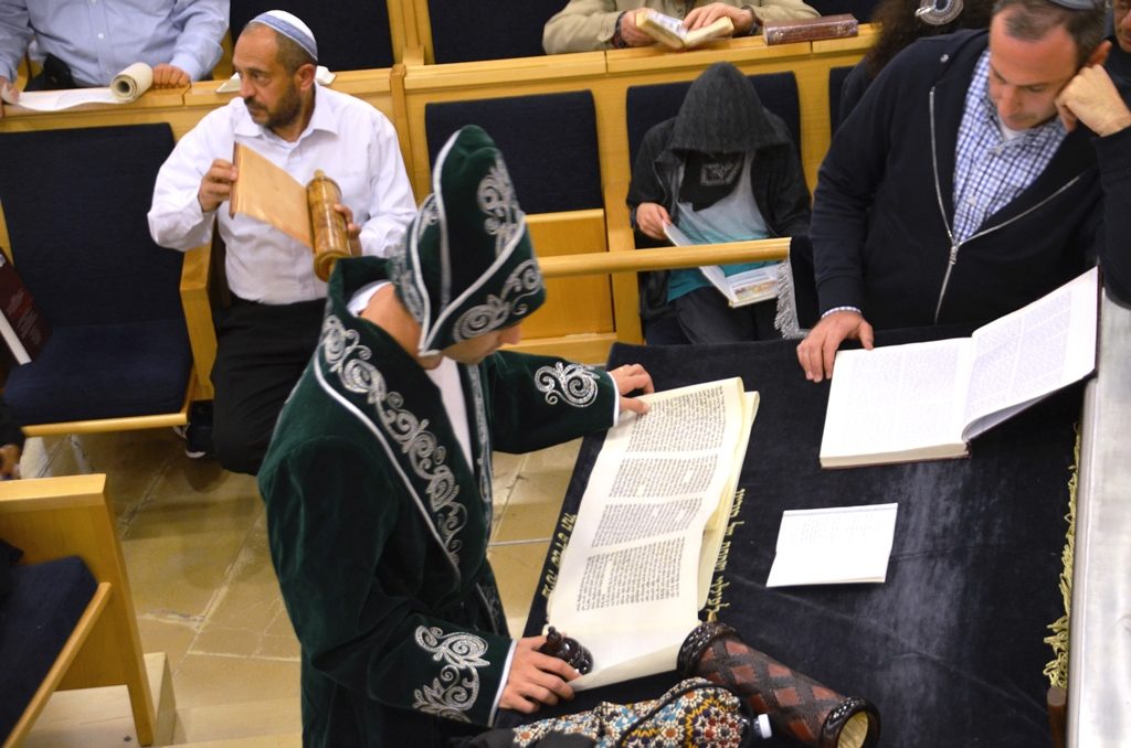 Jerusalem man reading megilla in costume 