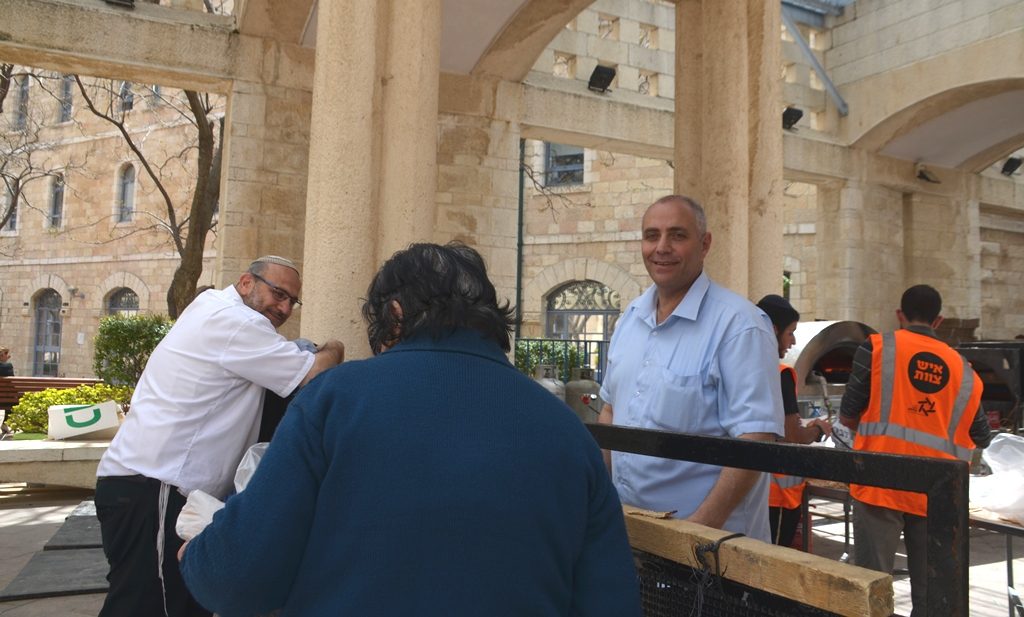 Matza baking in Jerusalem woman receives a hand matza to take home