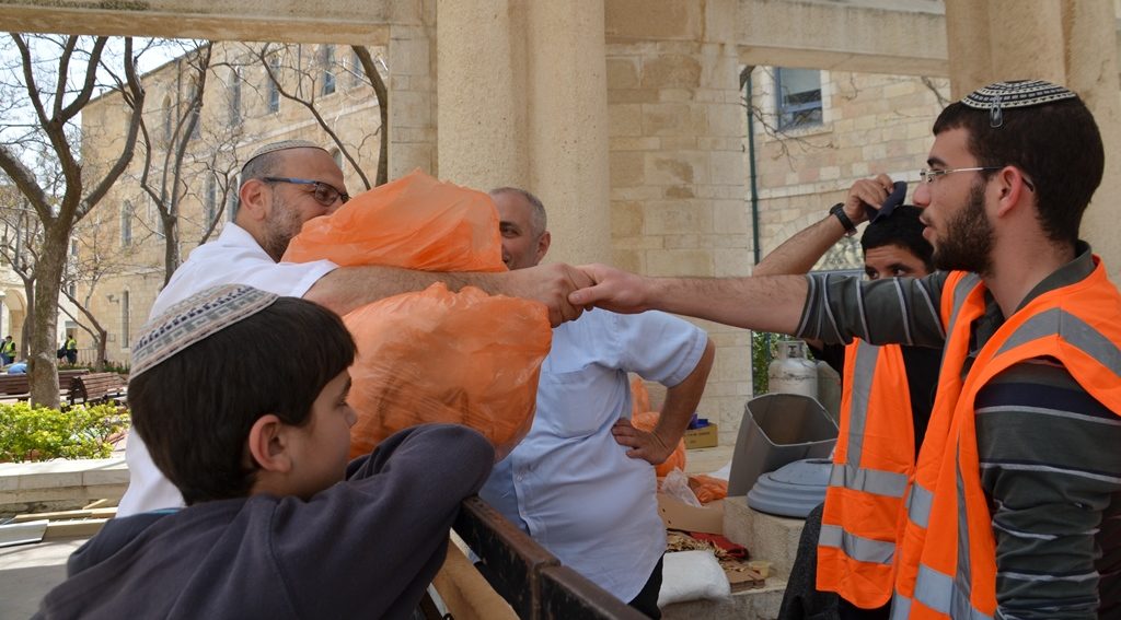Spring in Jerusalem matza baking man with large bag shakes hand of man working in Safra Square