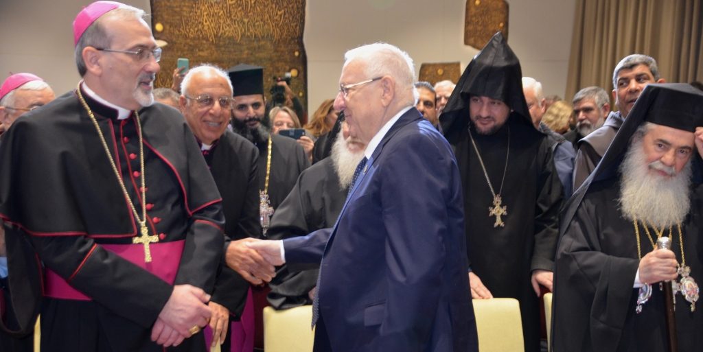 Israeli president shaking hands at new year reception with christian leaders