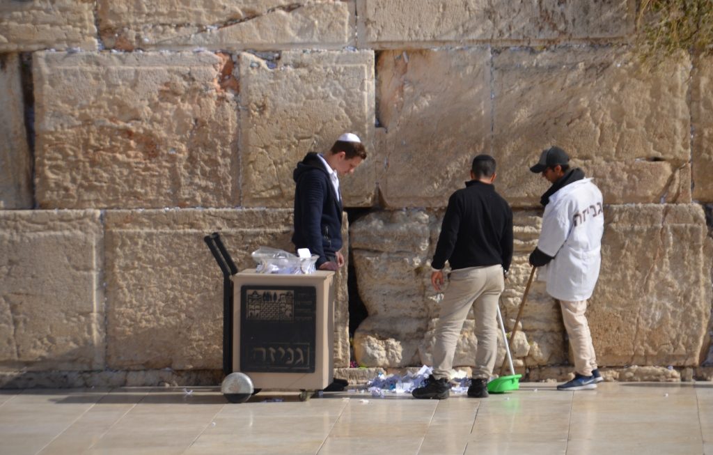 Cleaning the notes from Kotel in Jerusalem Old City 