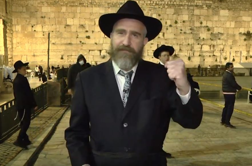Rabbi speaking on Facebook live for mass prayer event at the Kotel