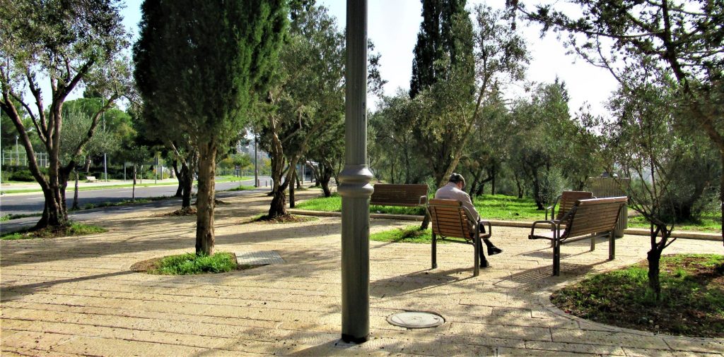 Man sitting in new Jerusalem outdoor area 