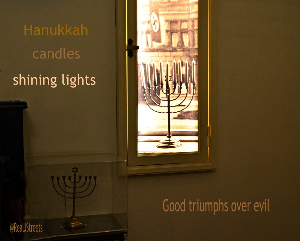 Hanukkah menorah display in Yad Vashem of photo and real menorah from Germany with Nazi flag in background