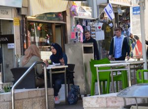 two arab girls eating in outdoor cafe